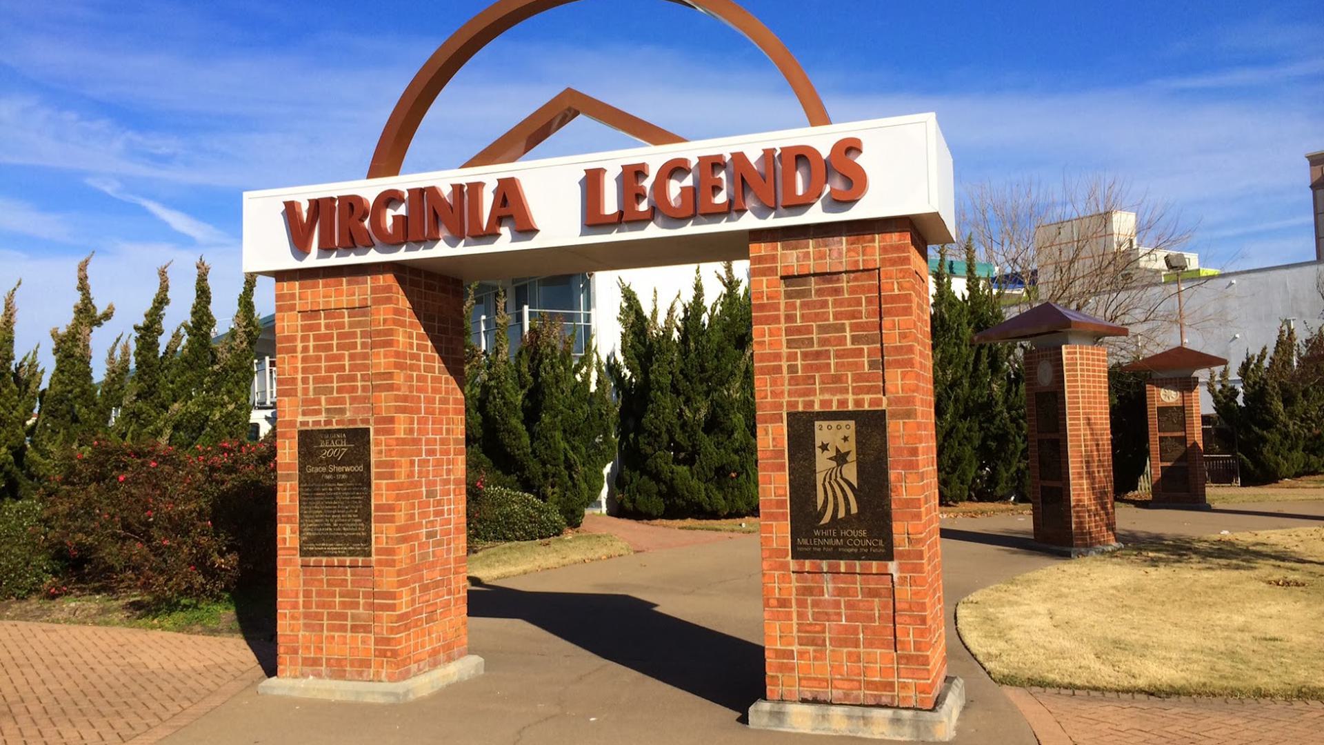 a photo of a sign connected to two brick pillars