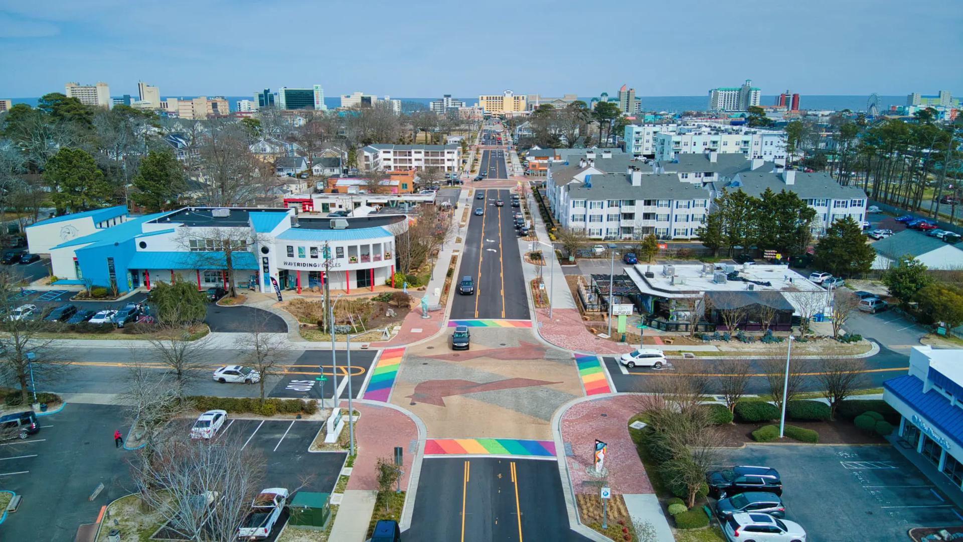 an aerial photo of a neighborhood with rainbow colored crosswalks