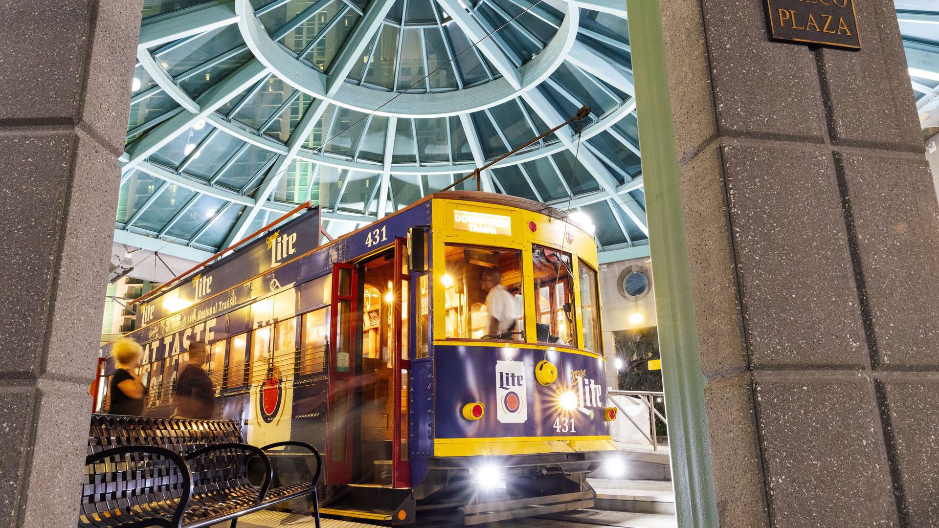 a view of a streetcar that's yellow and blue