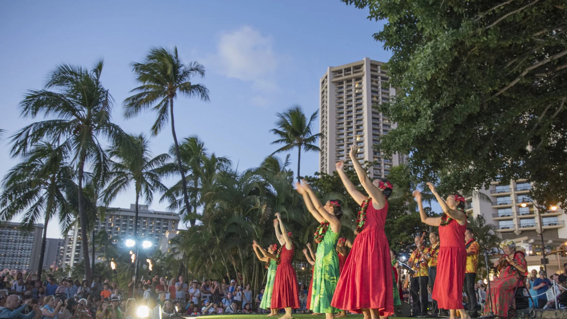 hula dancers on stage with palm trees