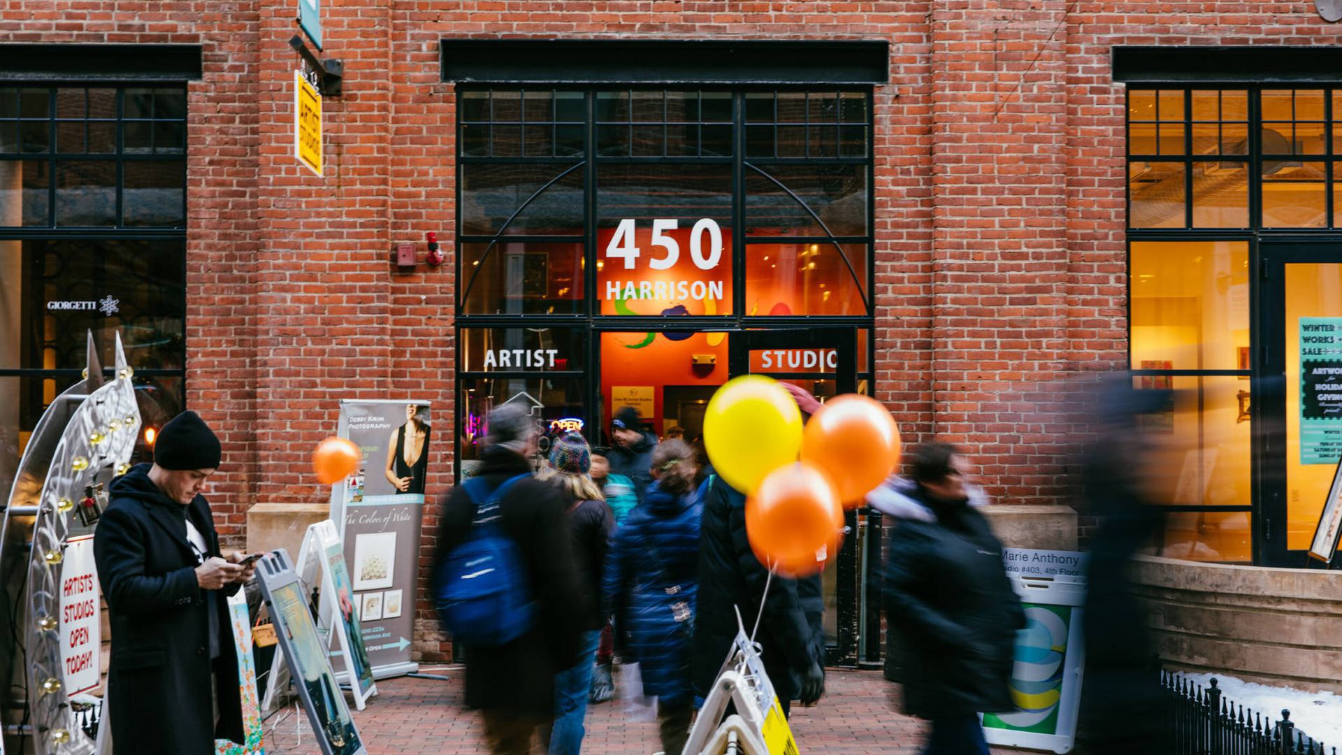 people walking into a brick building