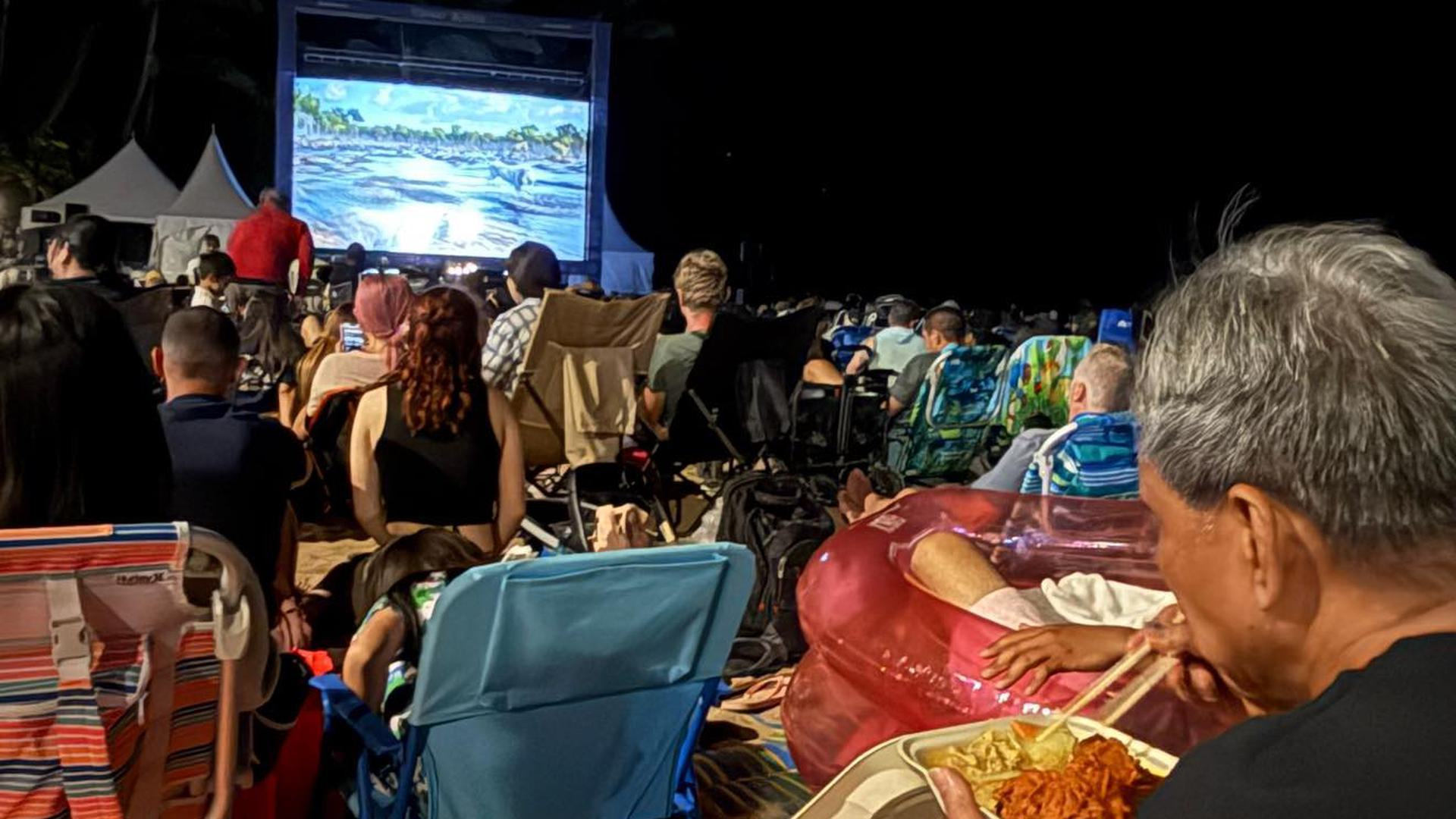 people watching a movie outdoors
