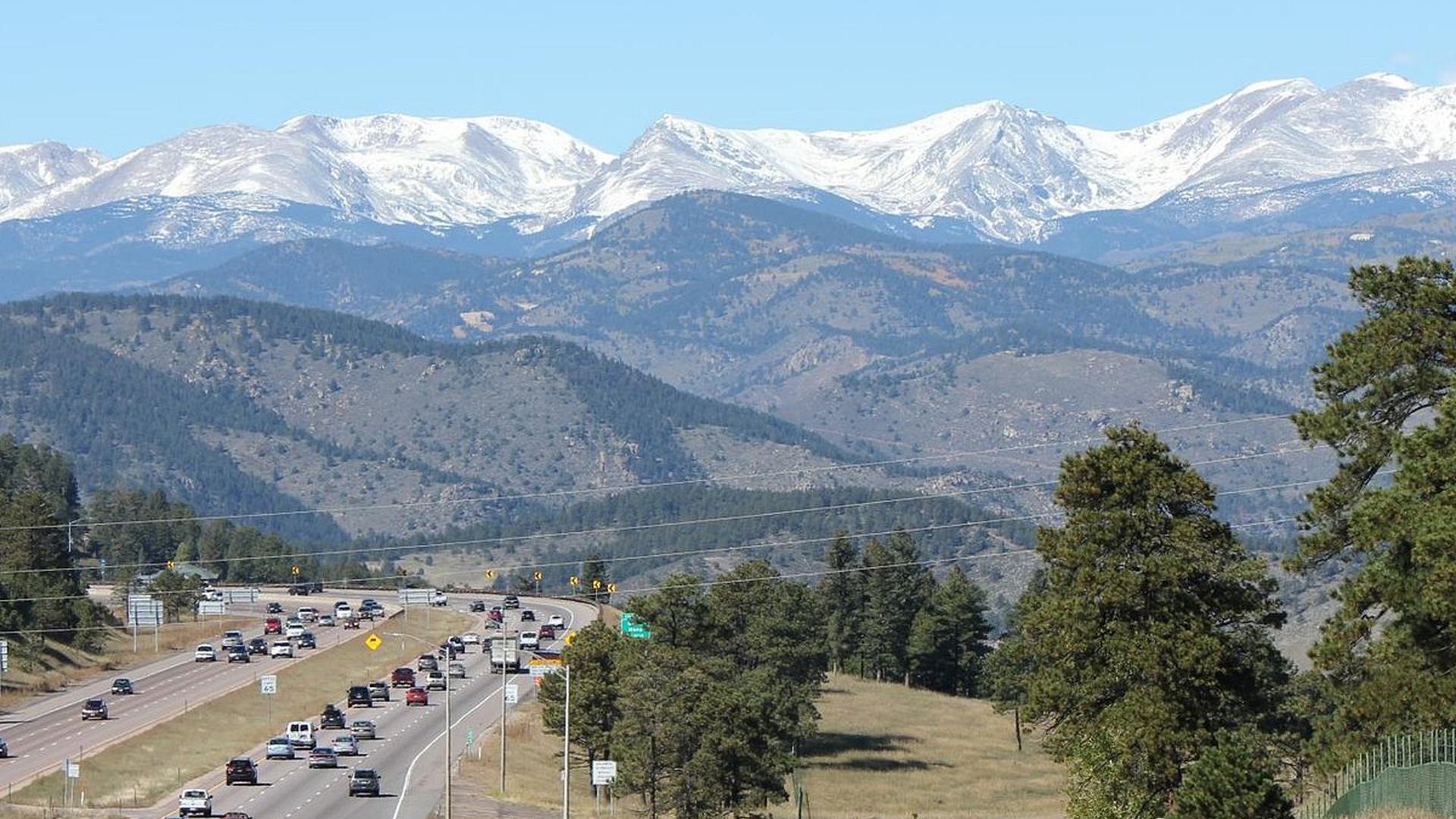 a scenic view of a road in the mountains