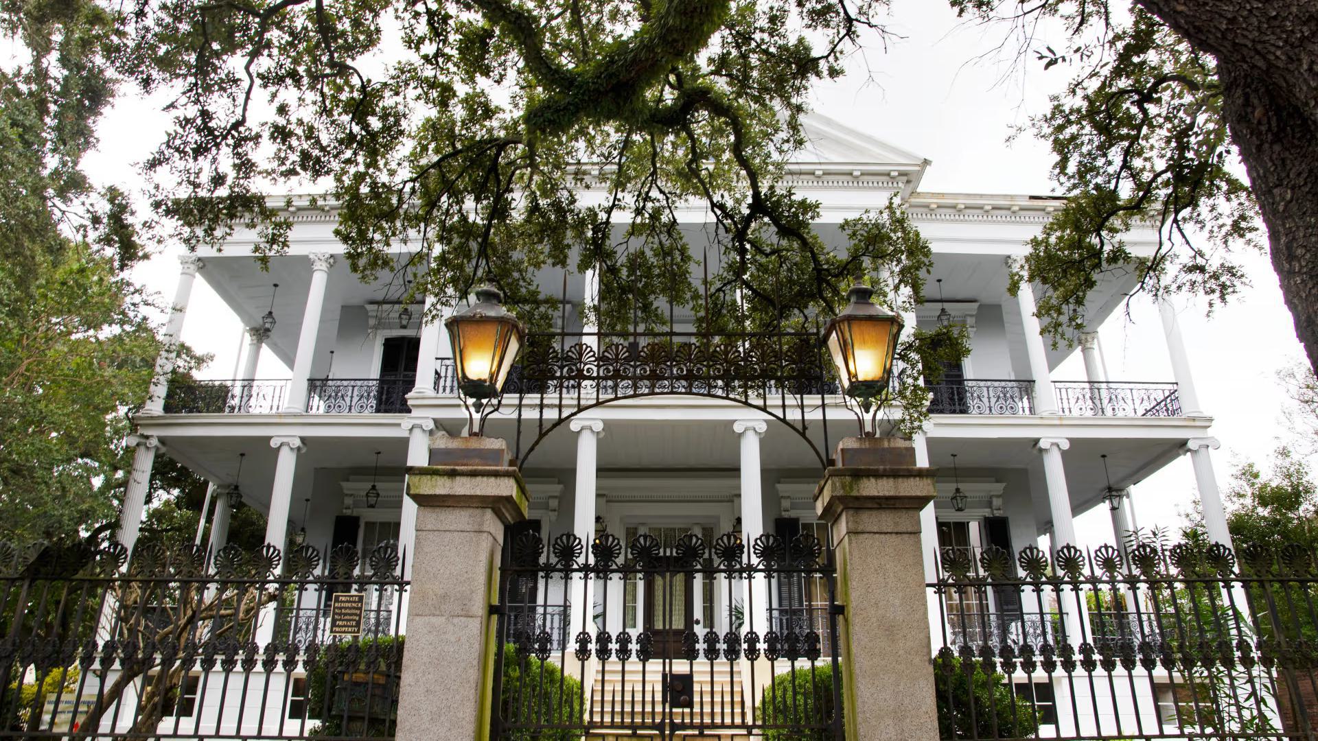the entrance to a gated white house