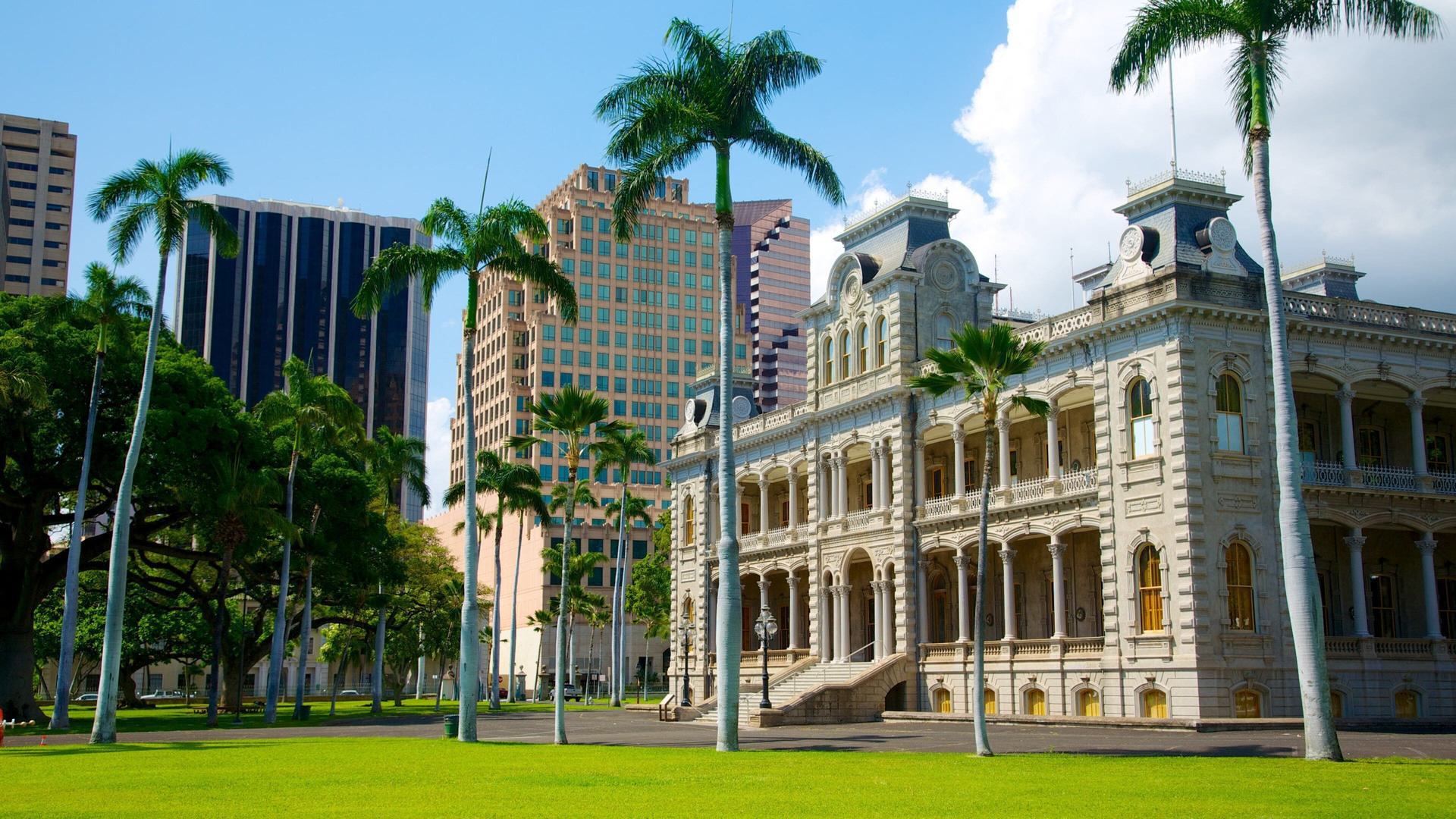 the outside of a palace and tall palm trees