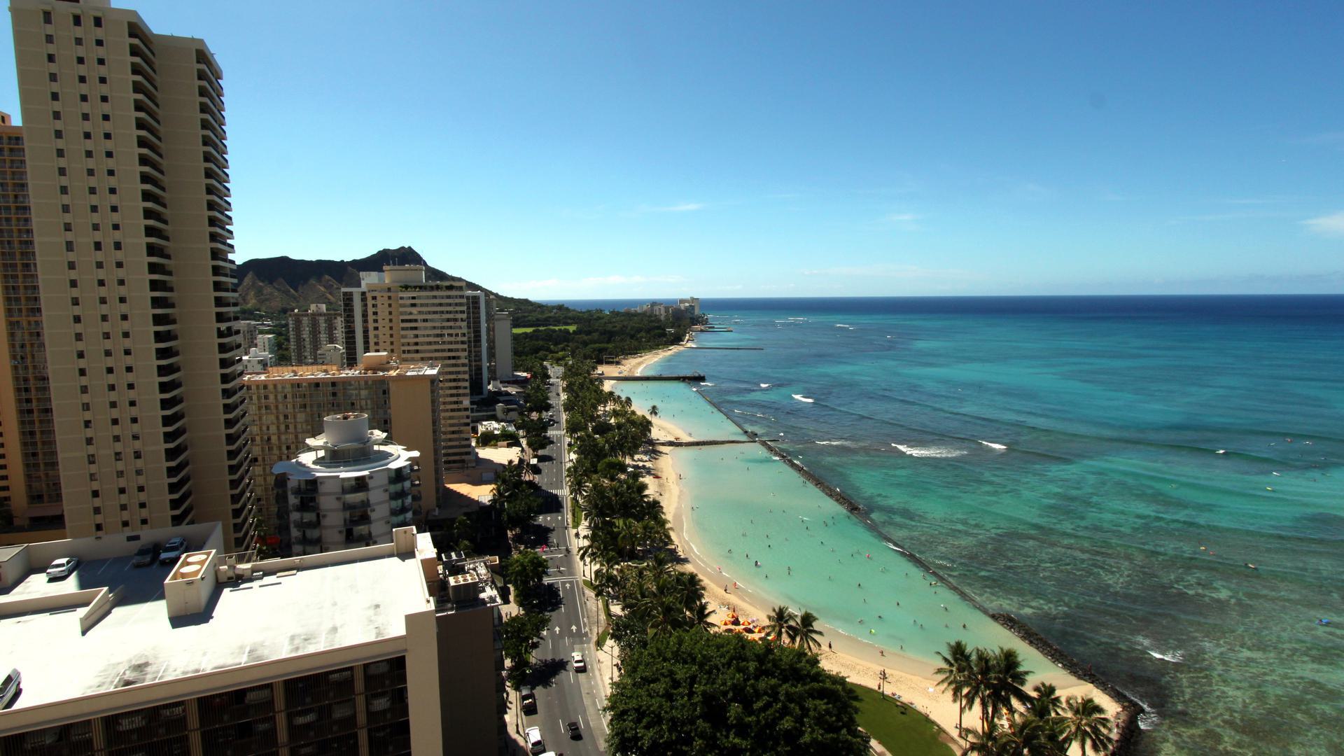 an aerial view of a beach and city