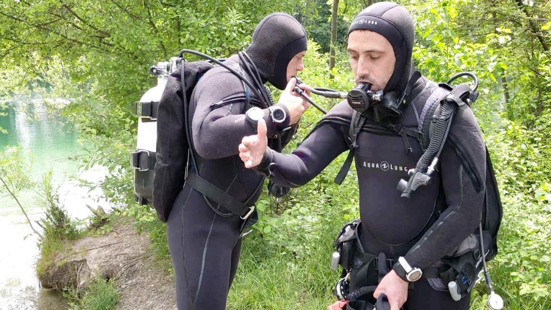two scuba divers testing their gear