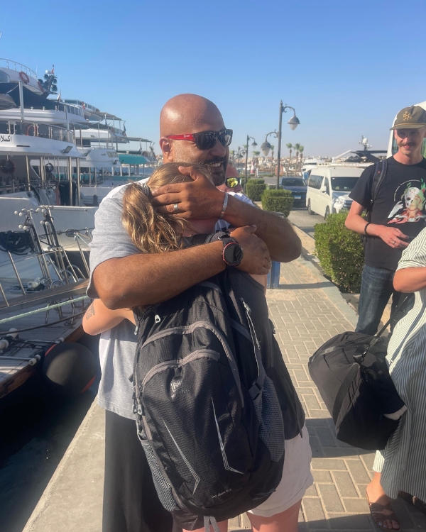 Photo of Scuba Jay's daughter Sofia saying goodbye to dive guide Ramzy.