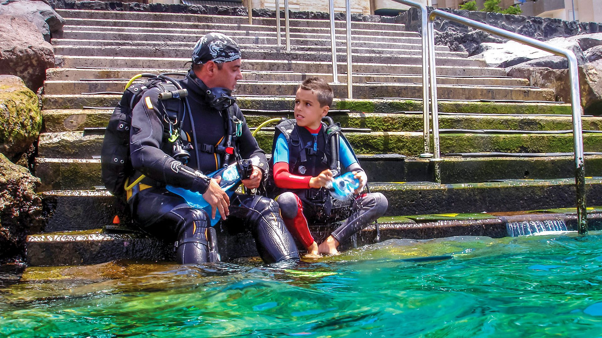 an older and younger scuba diver talking
