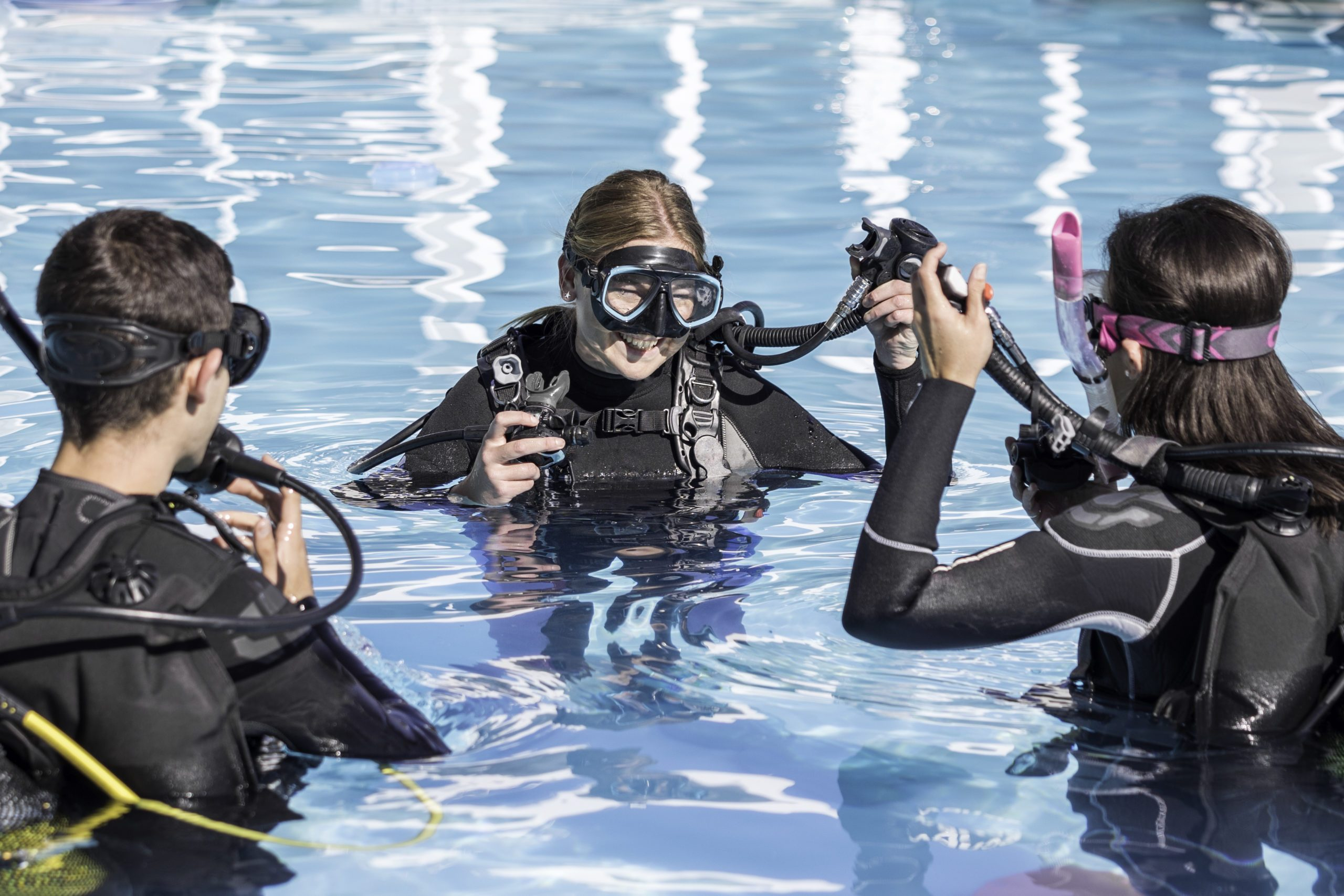 three scuba divers in the water